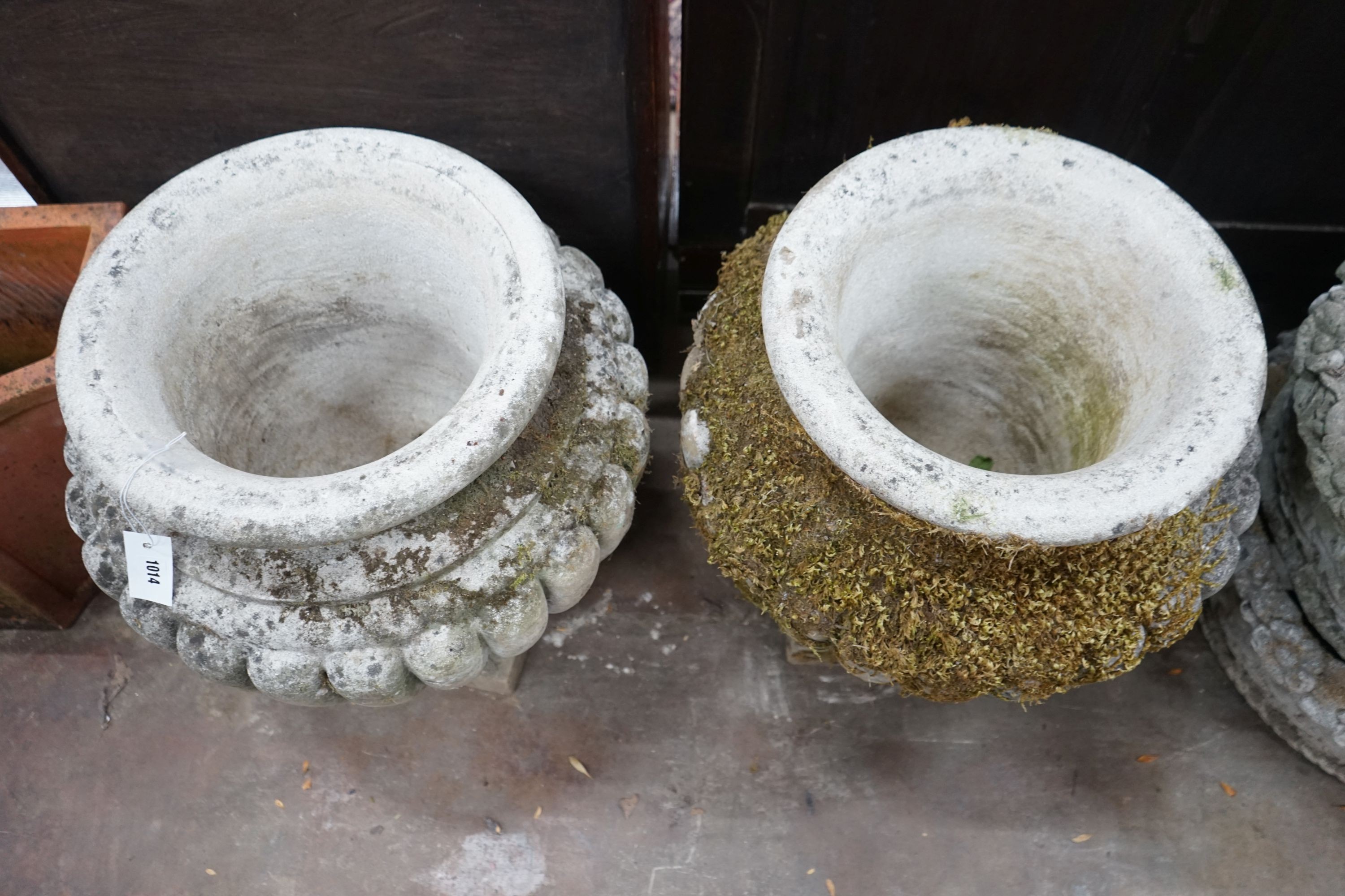 A pair of circular reconstituted stone garden planters, diameter 54cm, height 56cm